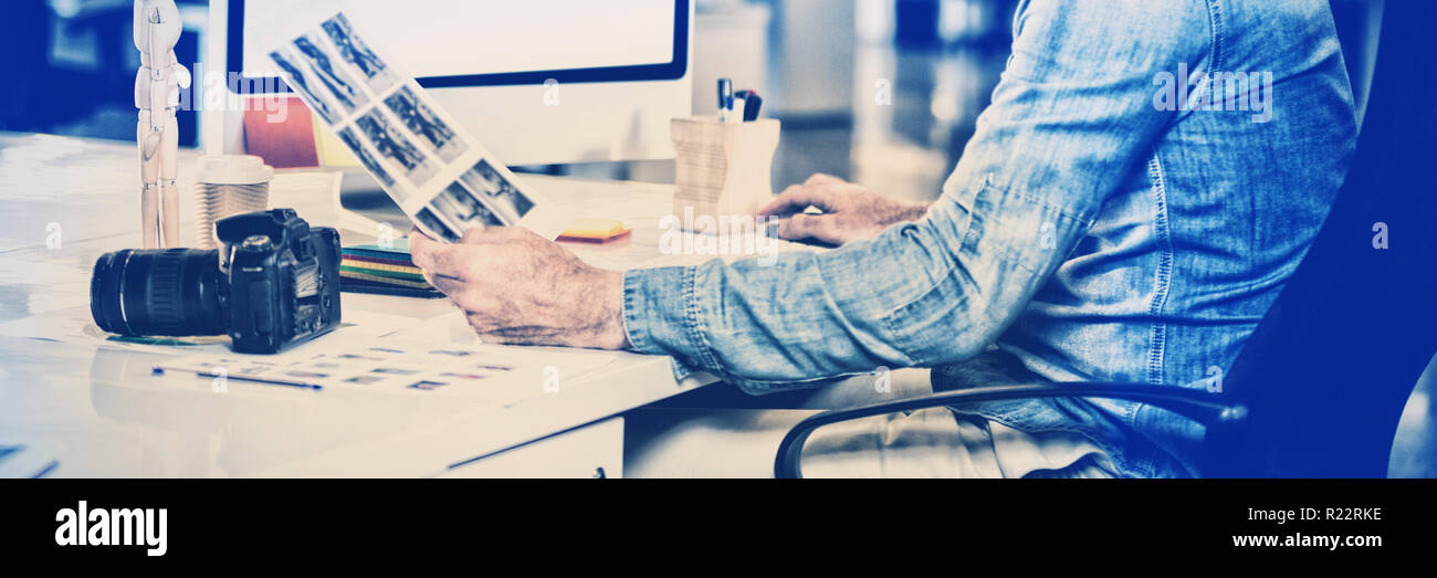 Photo editor working on computer Stock Photo