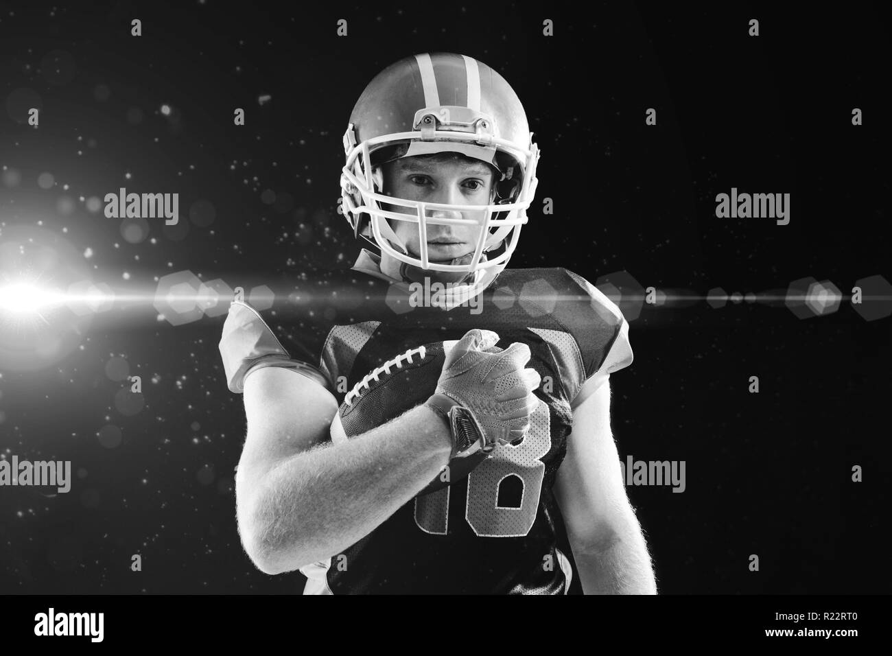 American football player in helmet holding rugby ball Stock Photo Alamy
