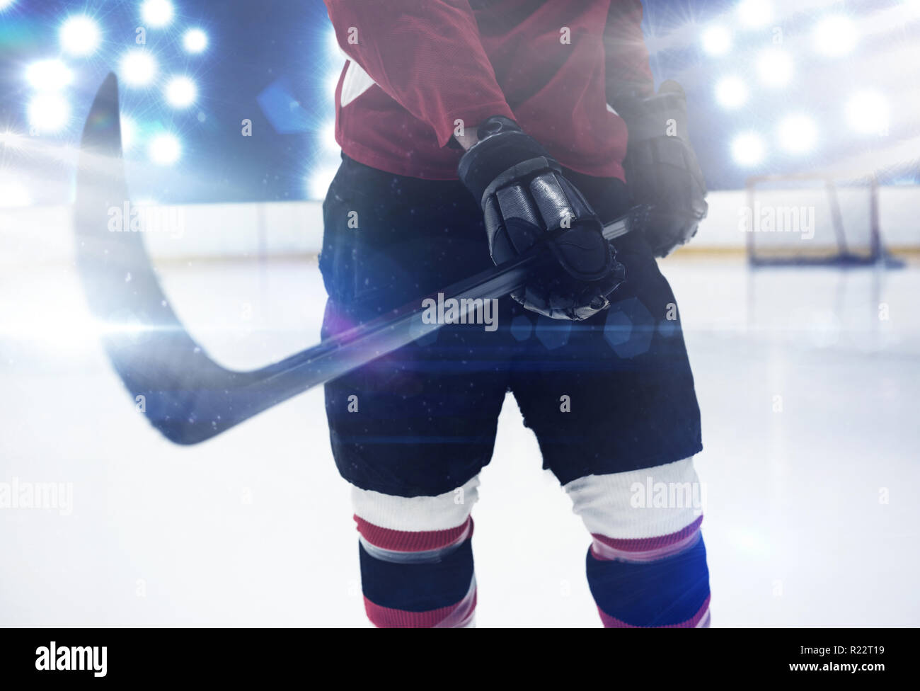 Composite image of mid section of hockey player holding stick Stock