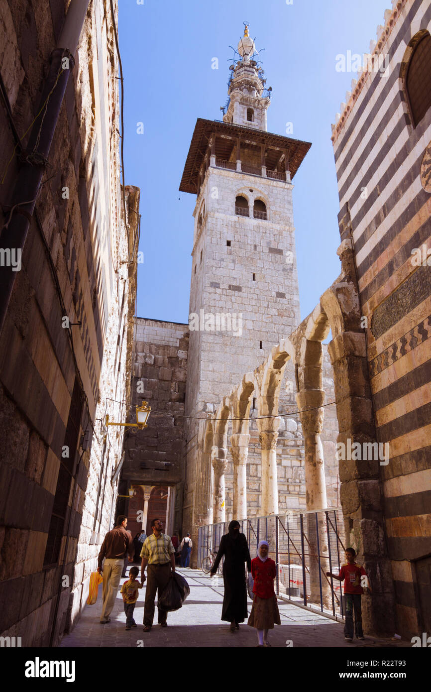 Damascus, Syria : Minaret of the Bride, the oldest of the Umayyad Mosque as seen from an alley in the old town. Stock Photo