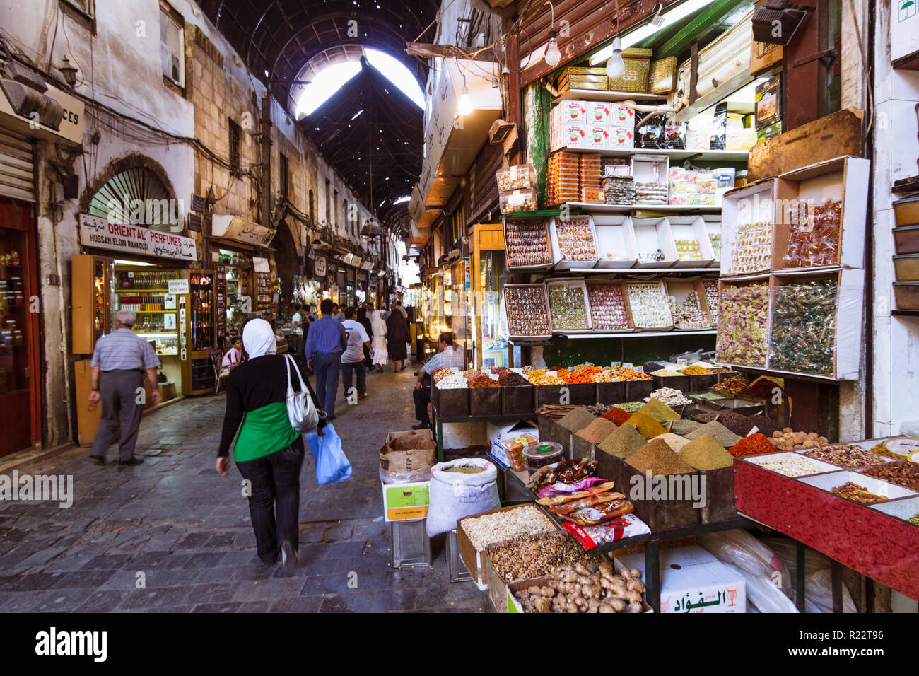 Damascus, Syria : A woman walks past grocery stores inside the Al-Hamidiyah Souq Stock Photo