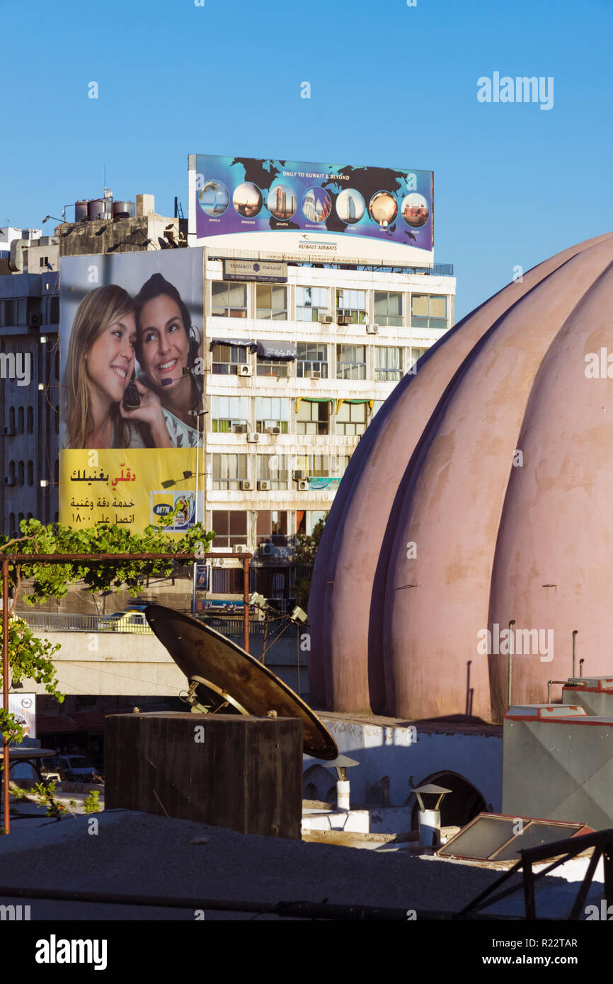 Damascus, Syria : Cityscape with old dome and modern billboard. Stock Photo