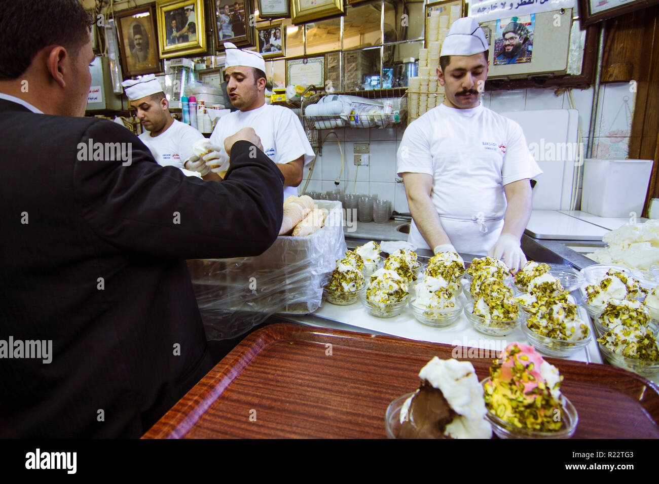 Damascus, Syria : Vendors and clients at Bakdash ice cream parlor. Established in 1885 in Al-Hamidiyah Souq, Bakdash is famous all around the Middle E Stock Photo