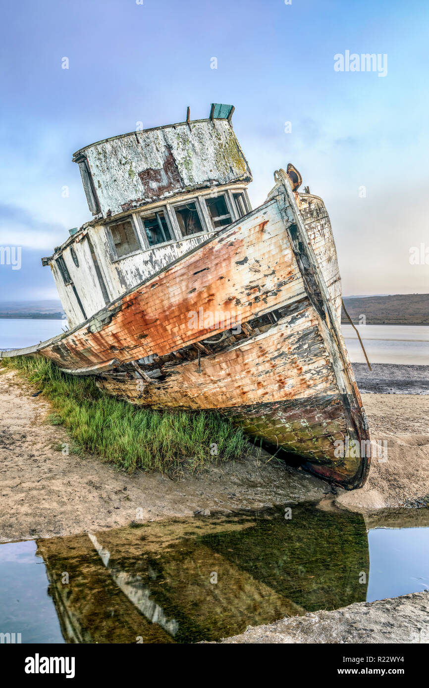 The old Point Reyes Boat, grounded in Tomales Bay at Inverness, California, has certainly seen better days. Stock Photo
