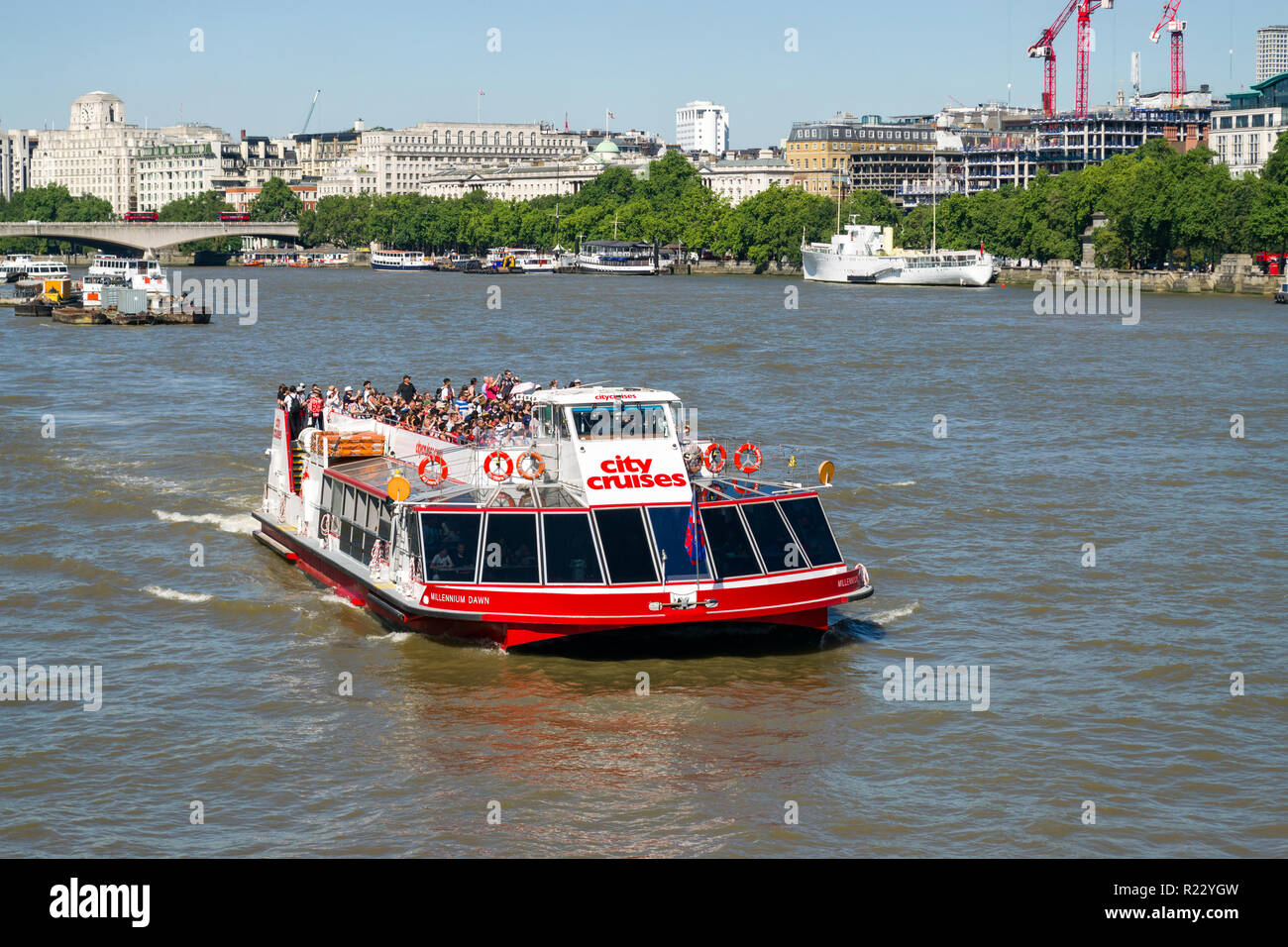Millenium Dawn, a M2 class passenger sightseeing transport catamaran with passengers on top deck near Blackfriars bridge, London, UK Stock Photo