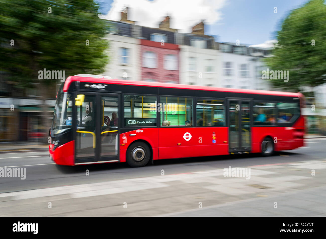 Panning image of a red Abelio bus as it travels along a road in London, UK Stock Photo