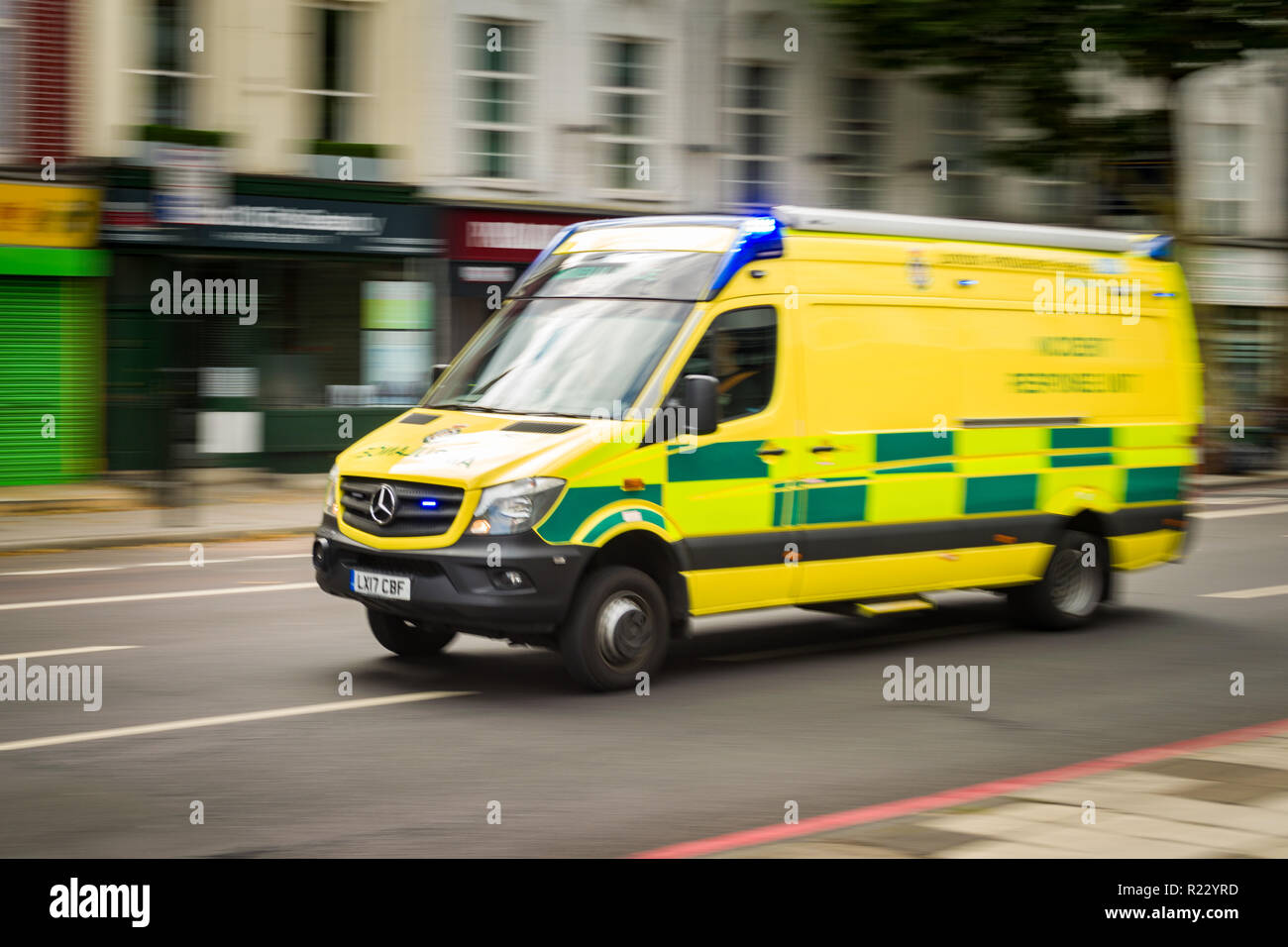 An Emergency Ambulance driving with flashing lights to an emergency