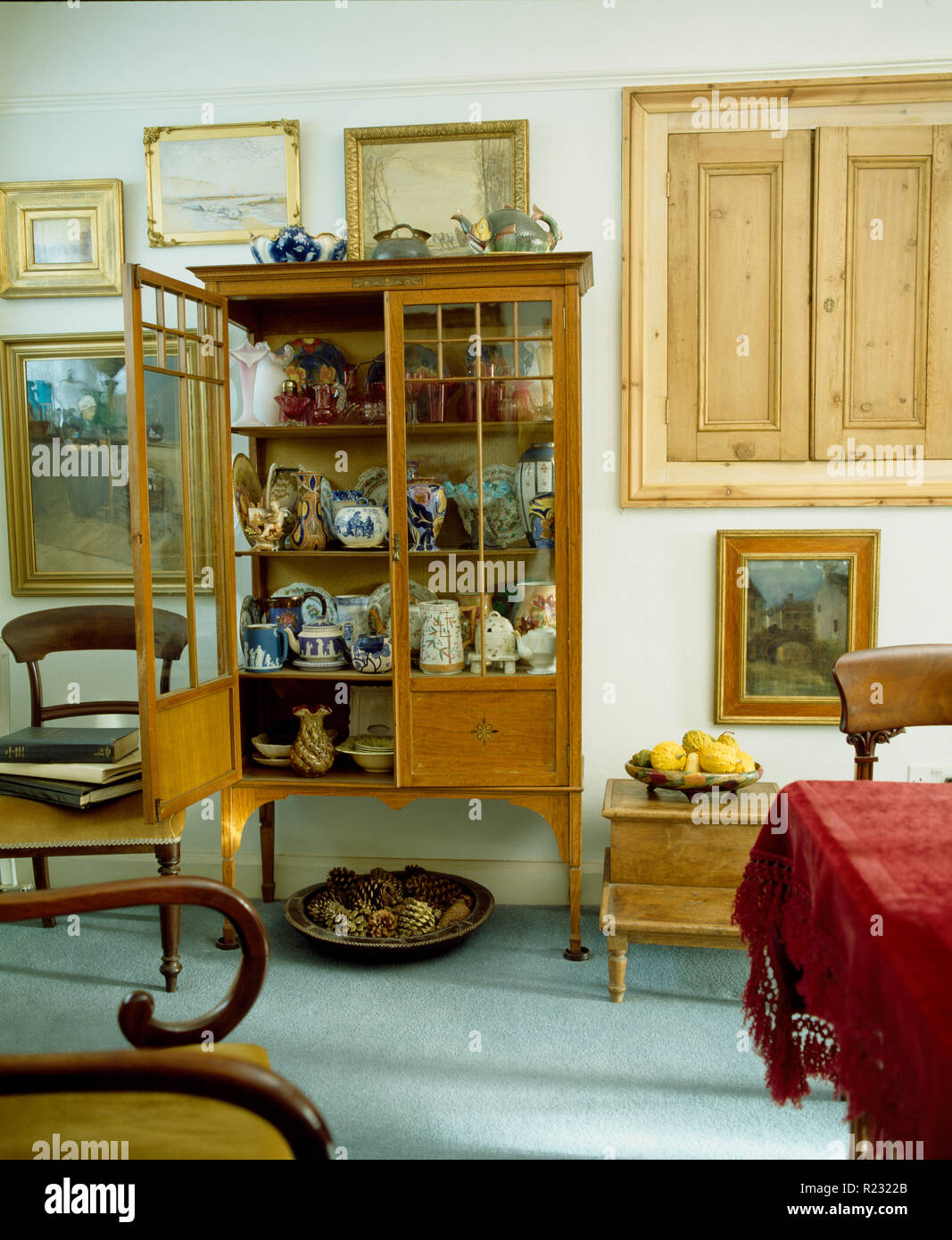 Antique glass front cabinet in old fashioned dining room Stock Photo