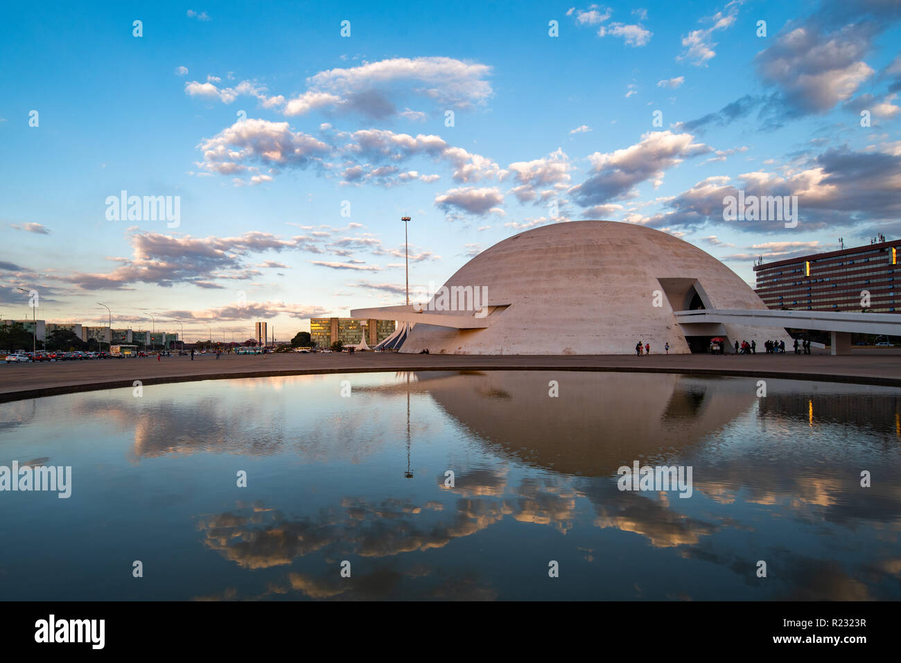 National Museum of the Brazilian Republic at sunset with a dramatic sky reflected in water feature Stock Photo