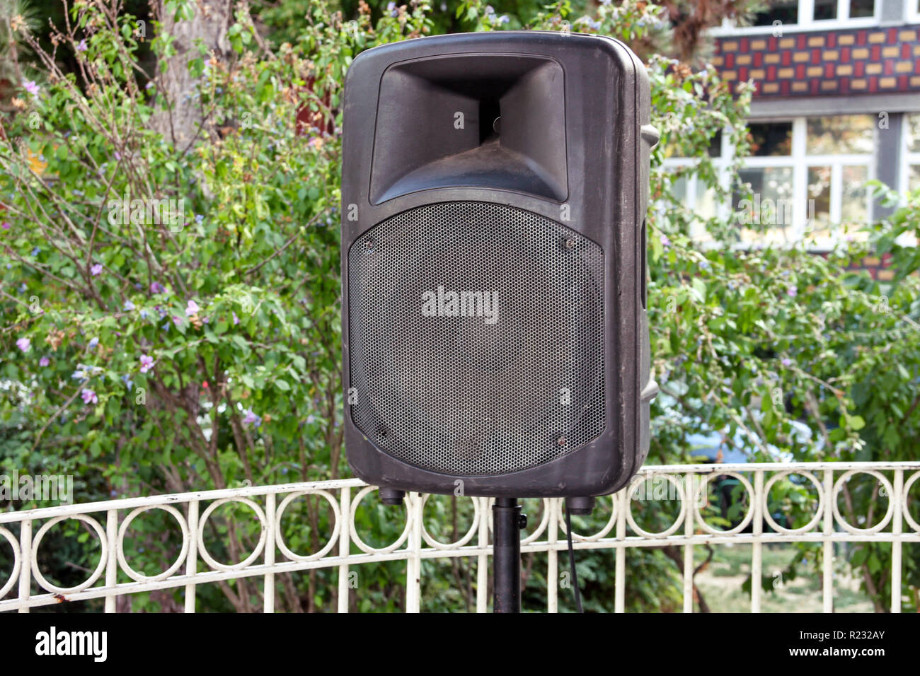 Black big speaker on stand outdoor / A big p.a. speaker on a stage at