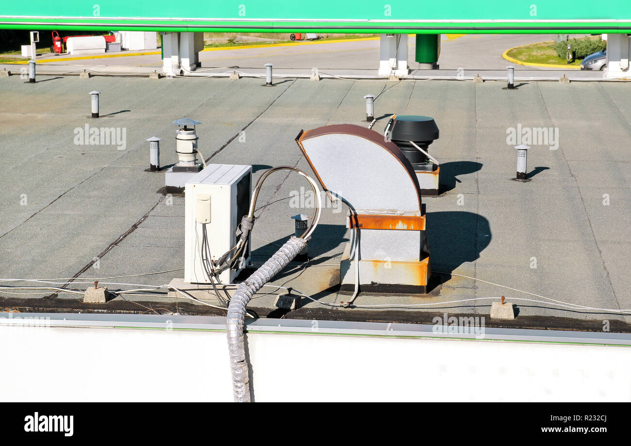 Air conditioning system assembled on top of a building / Air vents on top of commercial building / Air cooled water chillers top of roof. Stock Photo