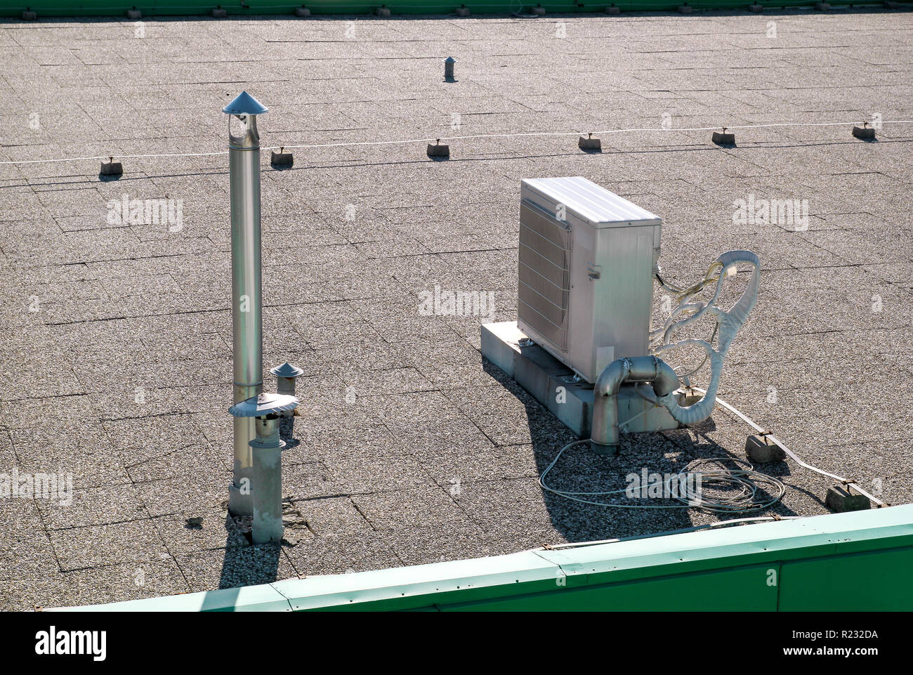 Air conditioning system assembled on top of a building / Air vents on top of commercial building / Air cooled water chillers top of roof. Stock Photo