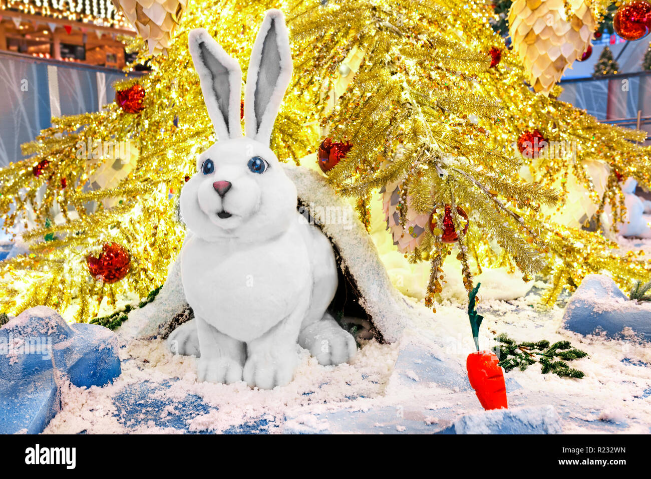 Toy rabbit sits under the Christmas tree Stock Photo Alamy