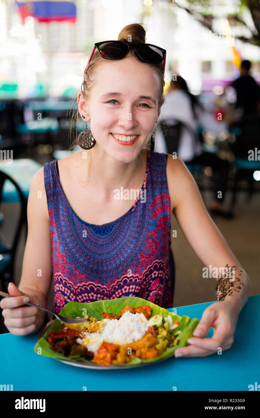 Beautiful girl having indian lunch on little india in Kuala Lumpur in