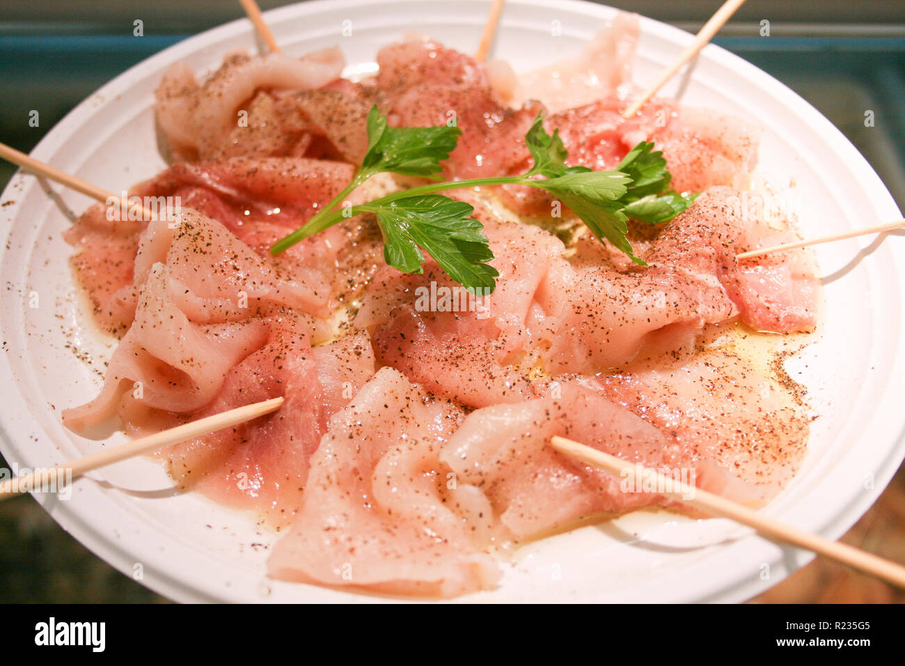A delicious carpaccio of fresh Mediterranean swordfish, seasoned with extra virgin olive oil, parsley, pepper and a few drops of lemon juice, sushi Stock Photo