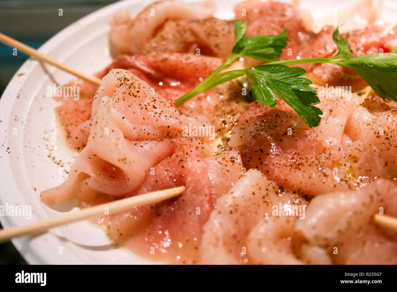 A delicious carpaccio of fresh Mediterranean swordfish, seasoned with extra virgin olive oil, parsley, pepper and a few drops of lemon juice, sushi Stock Photo