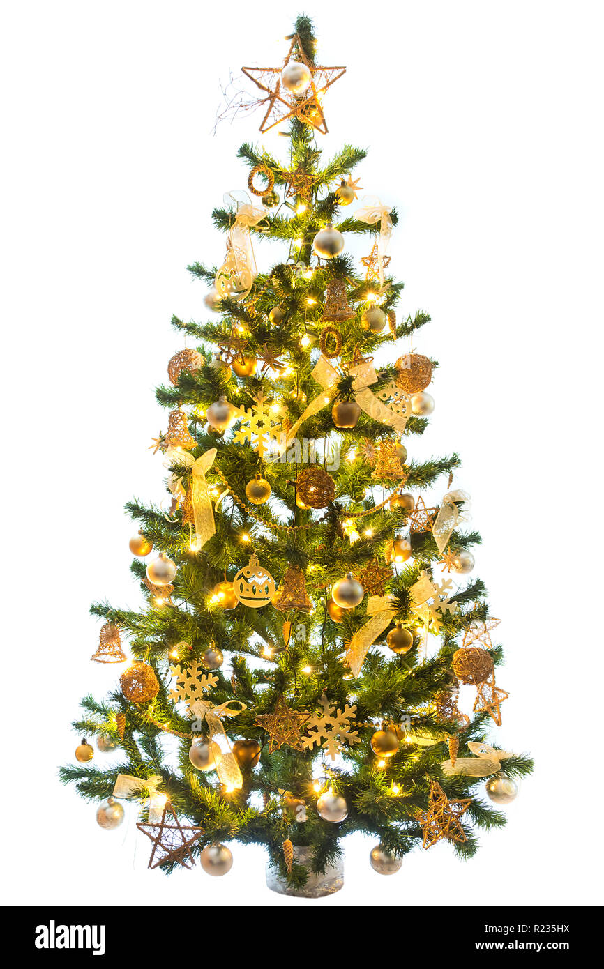 Christmas tree decorated with golden color with the light on a white ...