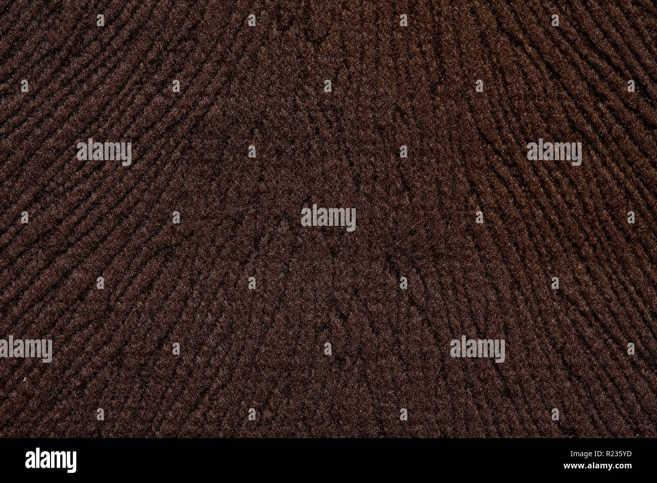 Relief tissue background in dark brown tone. Stock Photo