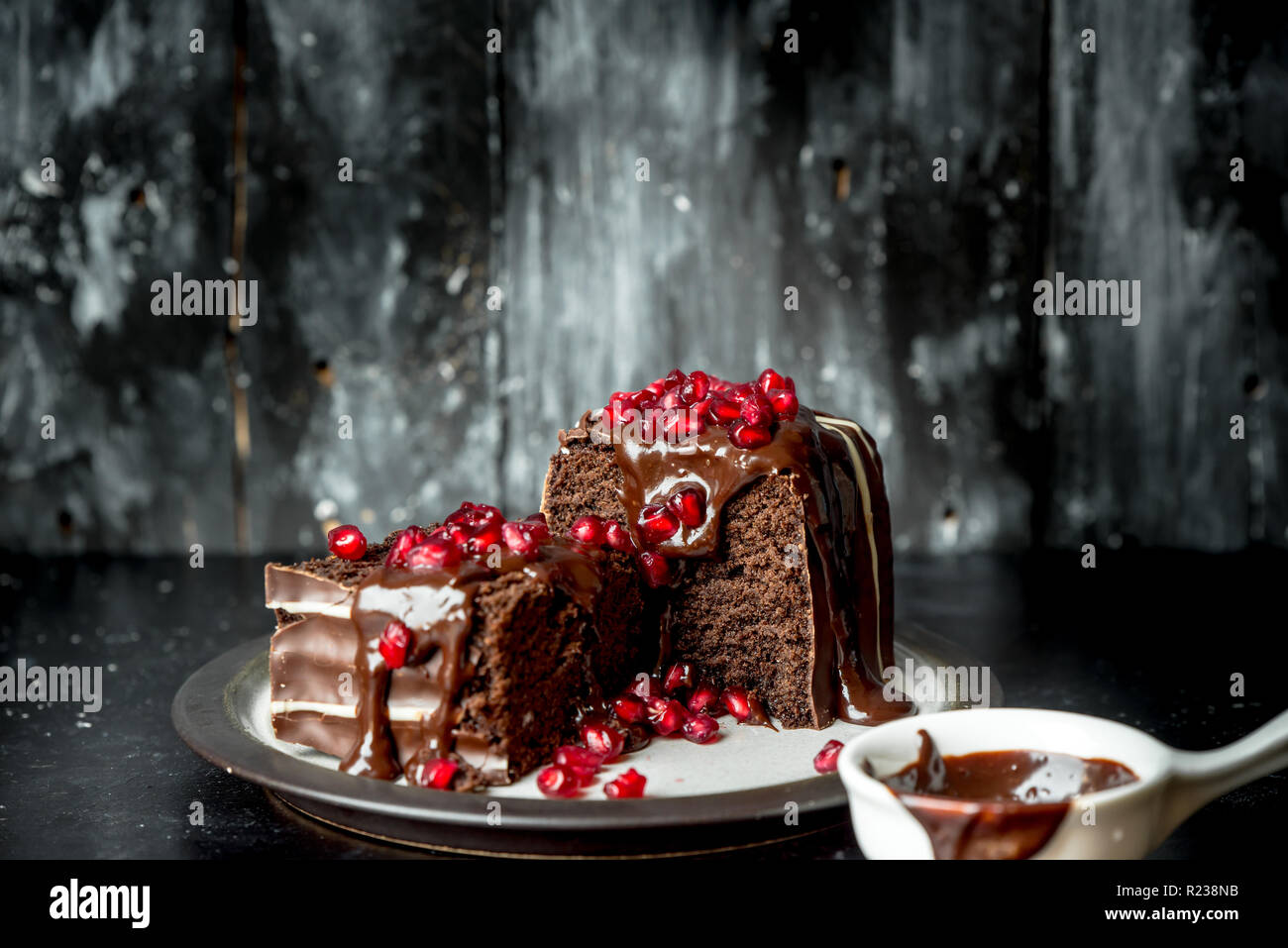 sweet moments - brownies poured hot, liquid chocolate and sprinkled with red pomegranate seeds Stock Photo
