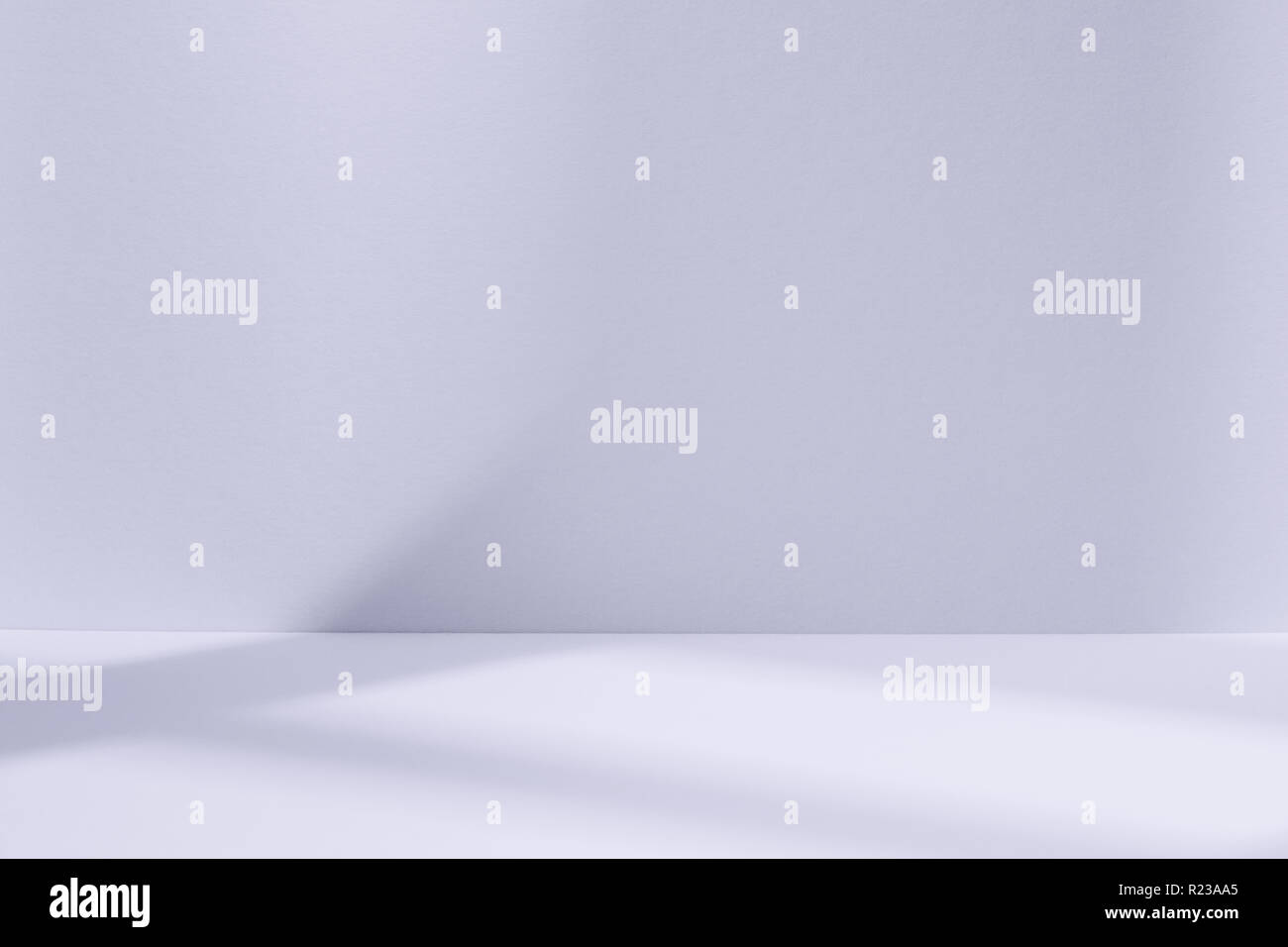 Empty light blue studio space with deep windows shadow. Sparse template and background Stock Photo