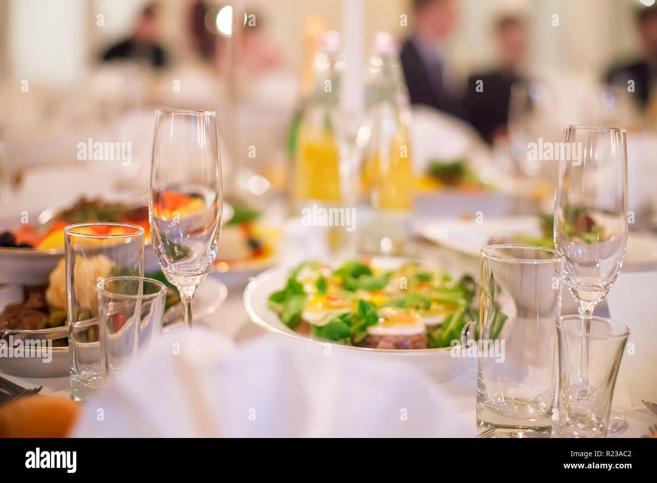 Catering banquet table with business people silhouette at background. Selective focus Stock Photo