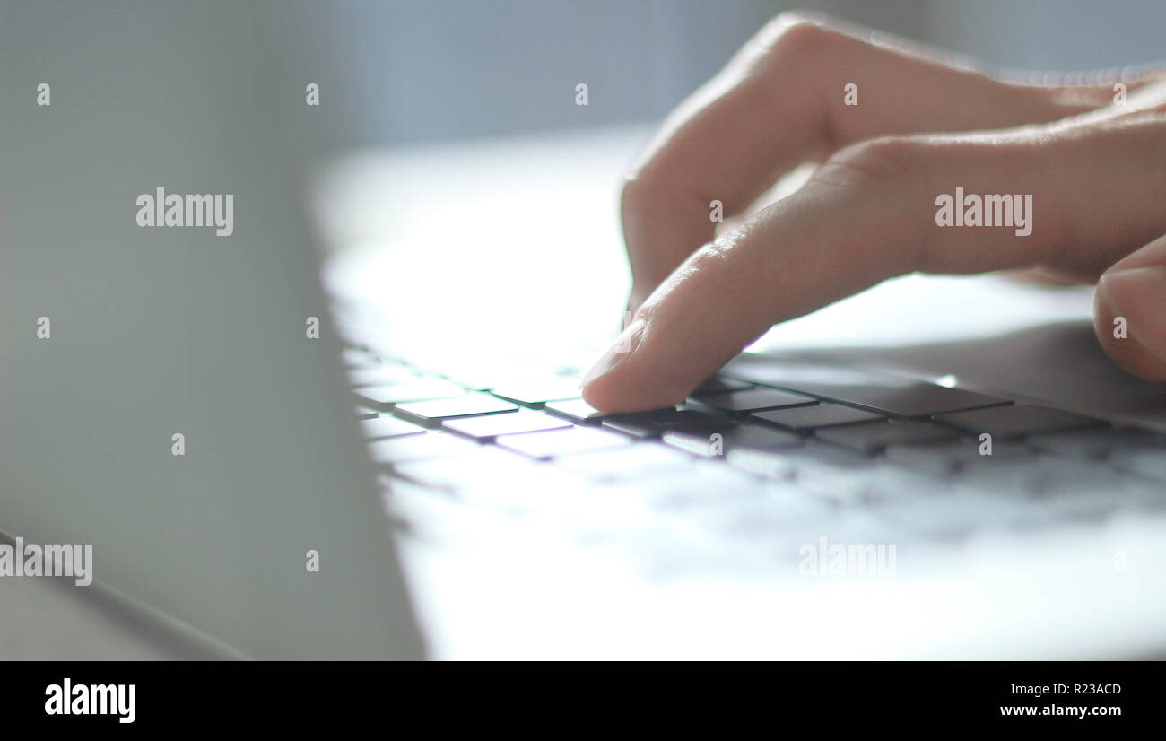 close up. blurred image of male hand typing on laptop keyboard Stock Photo