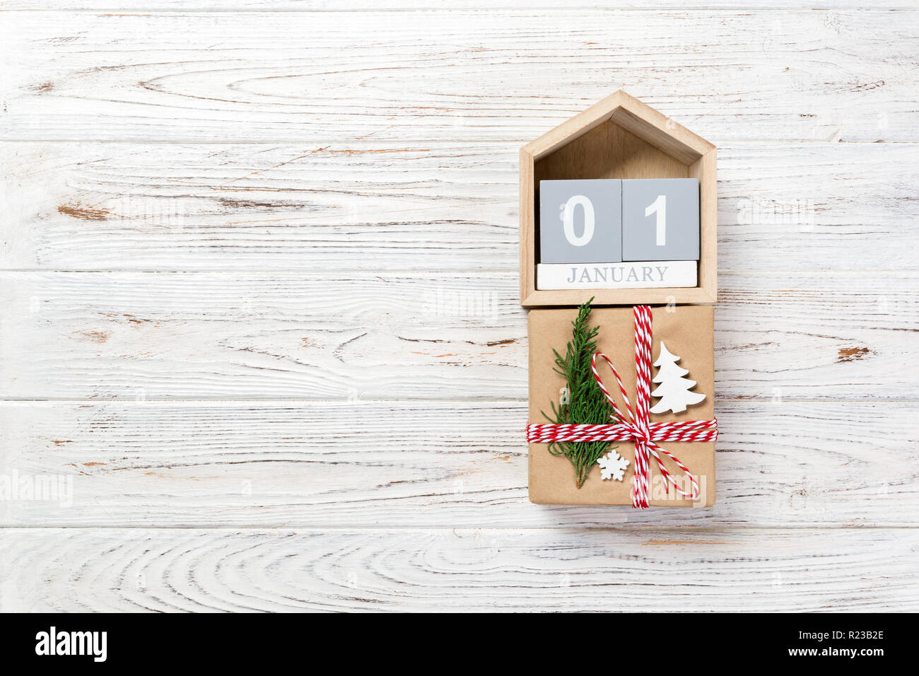 Box With January Calendar with date 1 january and gift boxes on color background ...