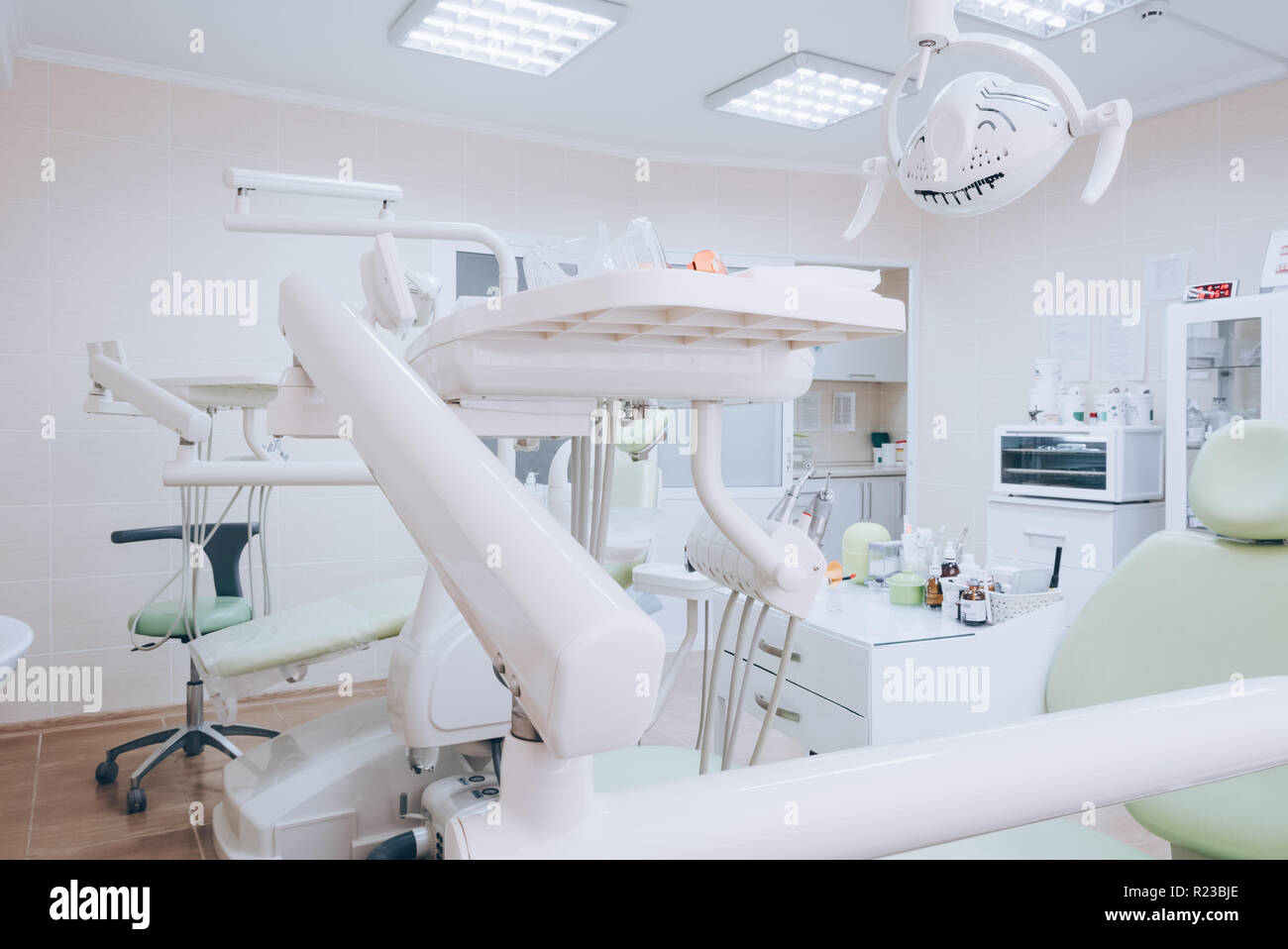 Dental clinic interior with modern dentistry equipment. Dental office.  White tone Stock Photo - Alamy