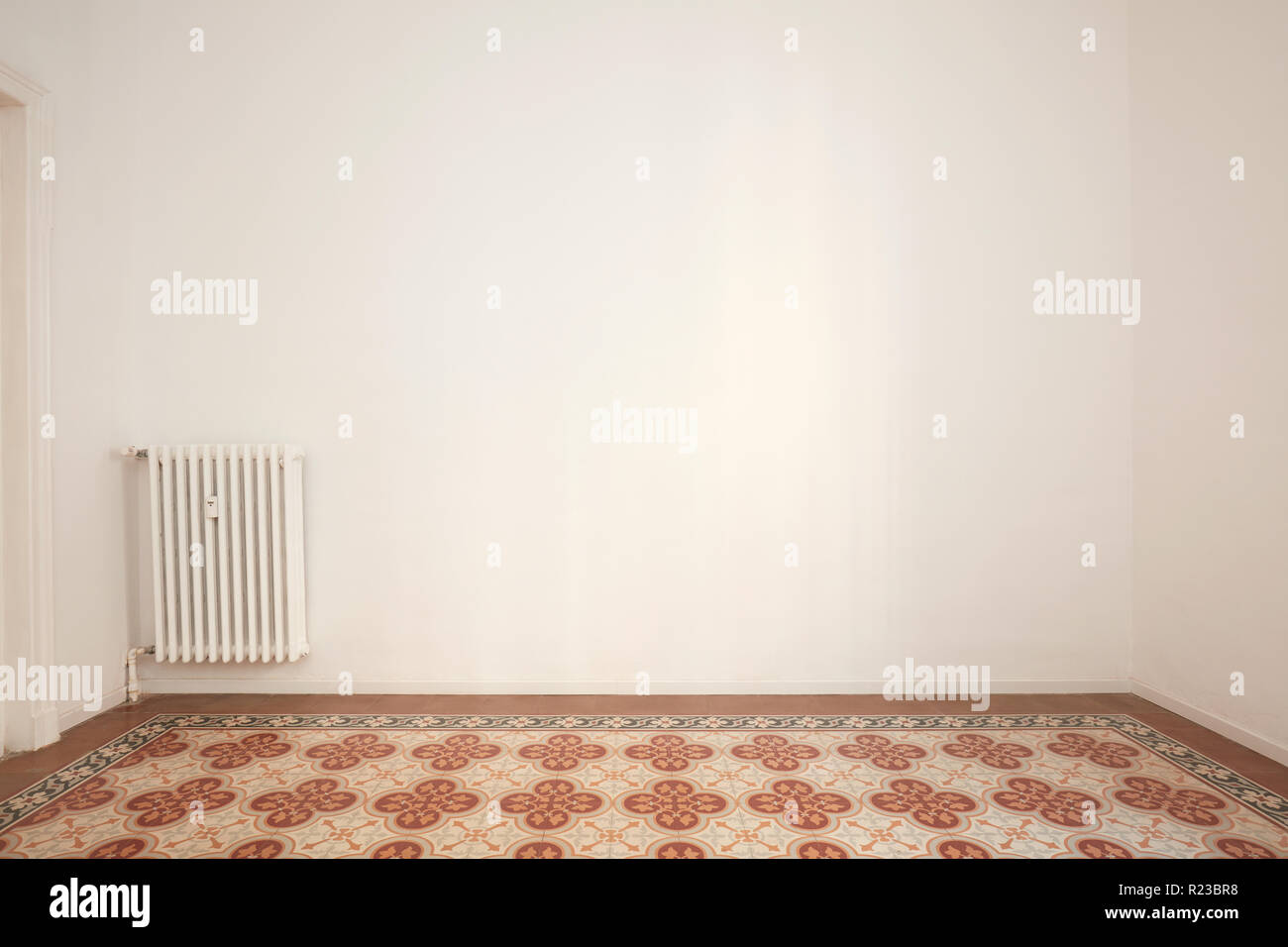 Blank, white wall and decorated floor in a renovated apartment Stock Photo