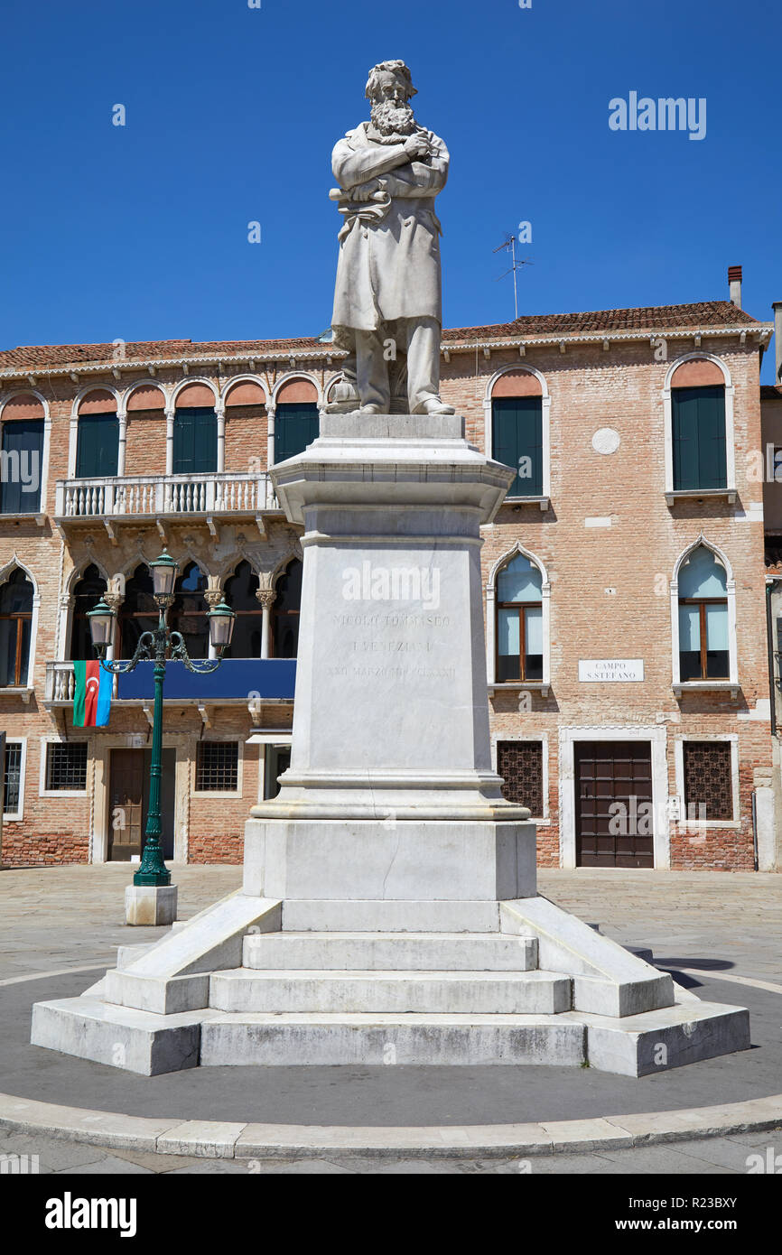Niccolo Tommaseo statue with pedestal in Venice by Francesco Barzaghi (1839-1892) in a sunny summer day in Italy Stock Photo