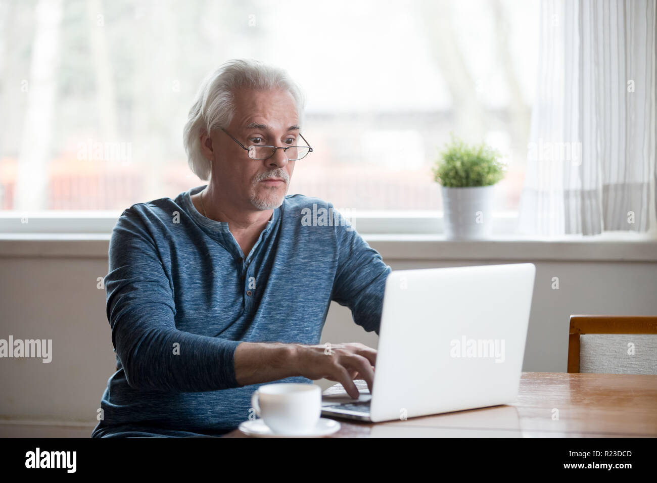 Surprised aged man stunned getting error or mistake message working at ...