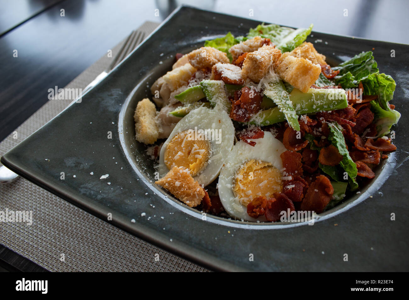 Caesar salad with egg, avocado, croutons, bacon and cheese Stock Photo