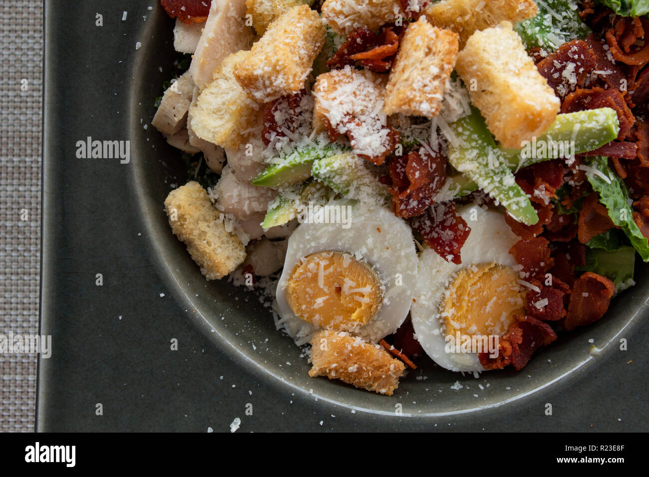 Caesar salad with egg, avocado, croutons, bacon and cheese Stock Photo