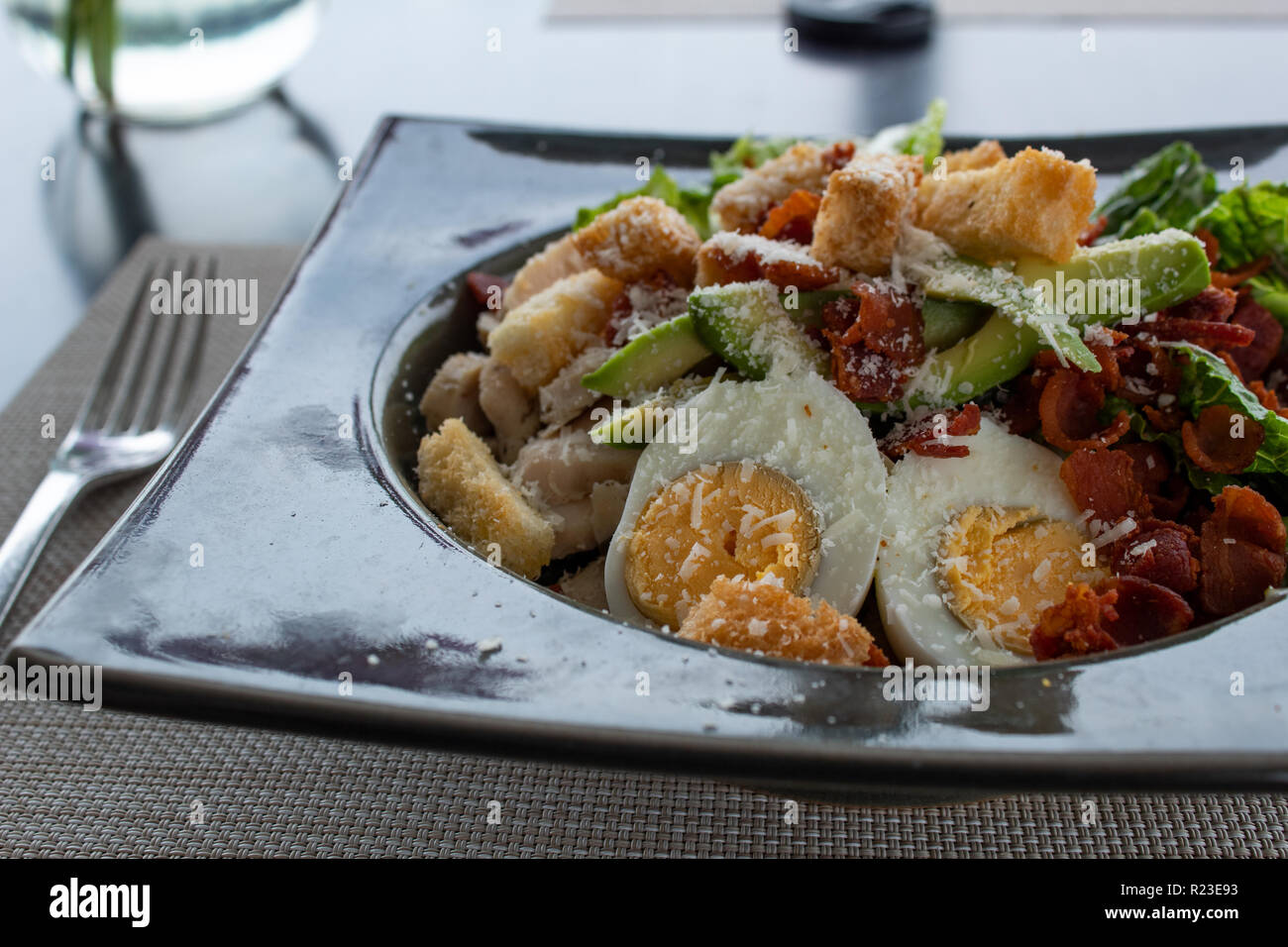 Caesar salad with egg, avocado, croutons, bacon and cheese Stock Photo