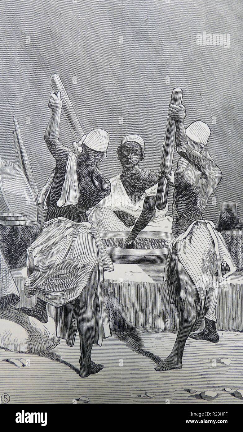Men pounding roasted coffee beans, Cairo, Egypt. Engraving, London, 1882. Stock Photo