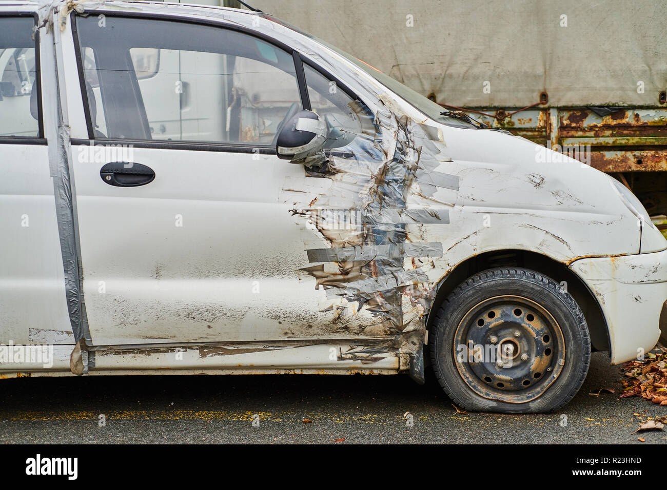 Damaged whire small car with duct tape repair Stock Photo Alamy