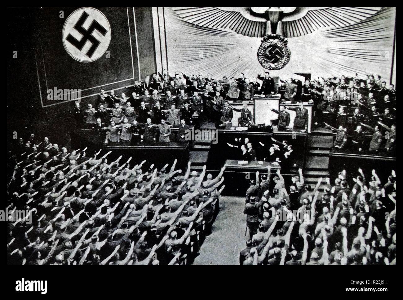 Photograph of a Reichstag Rally from the Kroll Opera House, in Berlin. Hitler addresses the Reichstag putting forward proposal for peace which was denounced by M. Daladier. Hitler is shown in the front row with Hess and Ribbentrop next to him. Dated 1939 Stock Photo