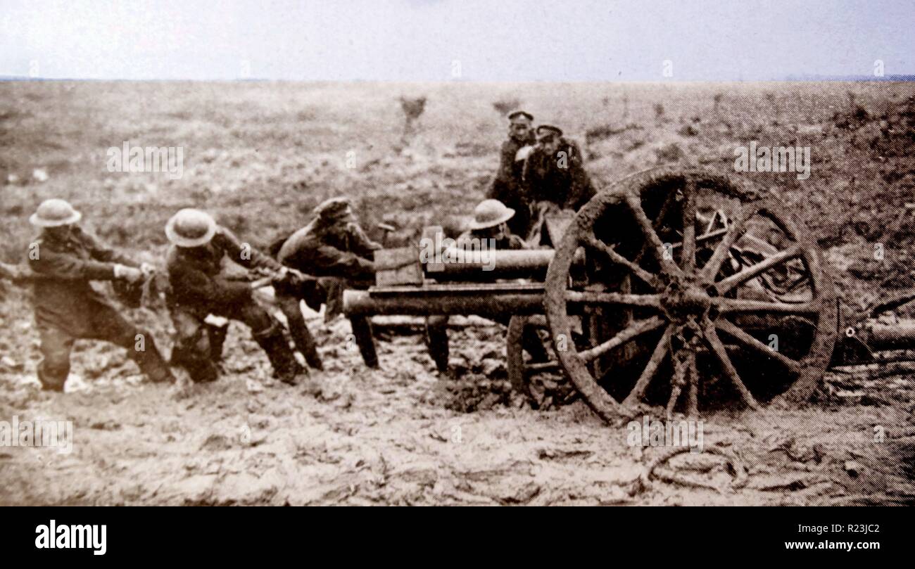 World war one British artillery gun is hauled through mud into a firing