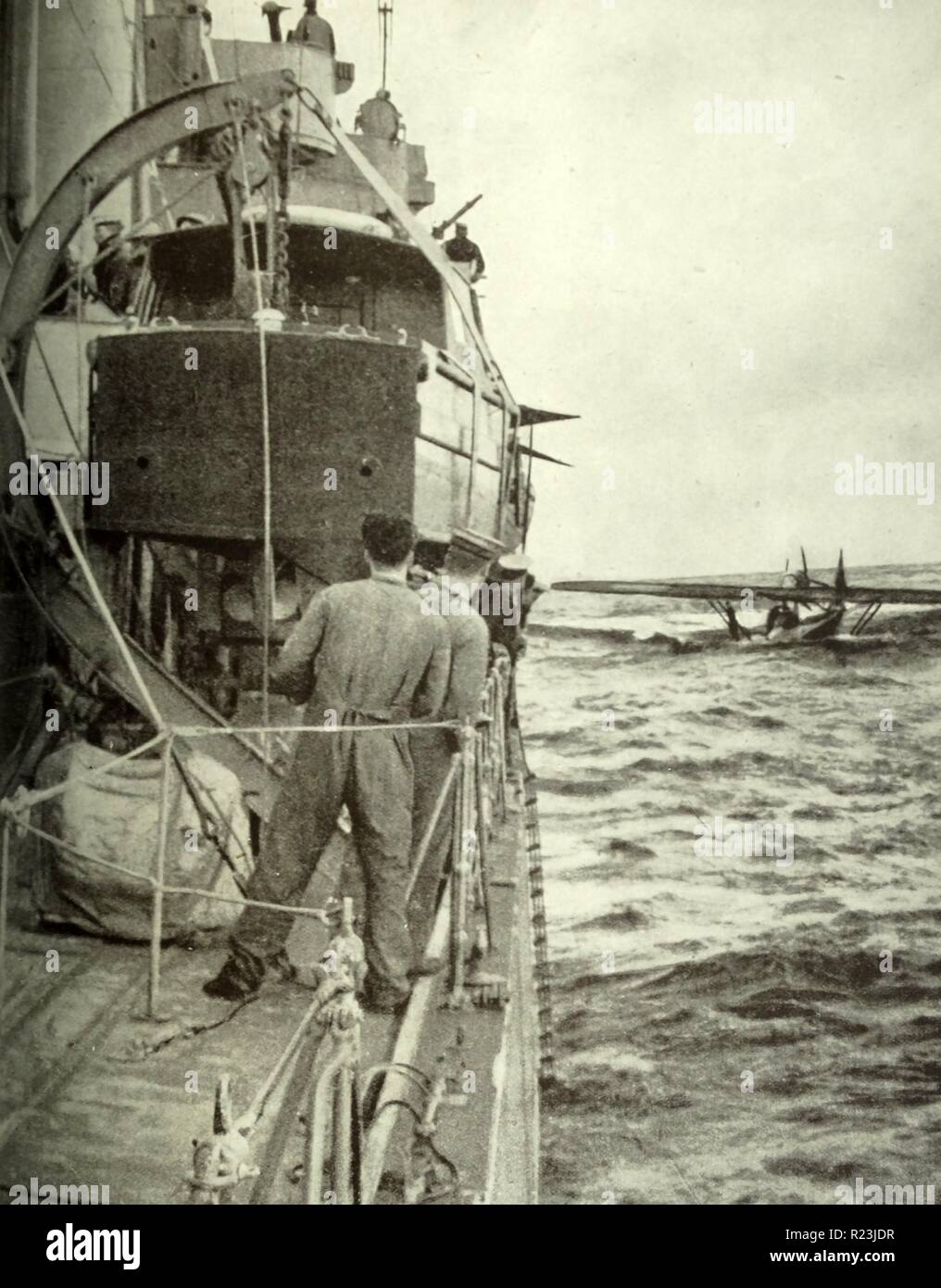 Photograph of the crew of the German aircraft brought down is being rescued by a British Destroyer. Dated 1939 Stock Photo