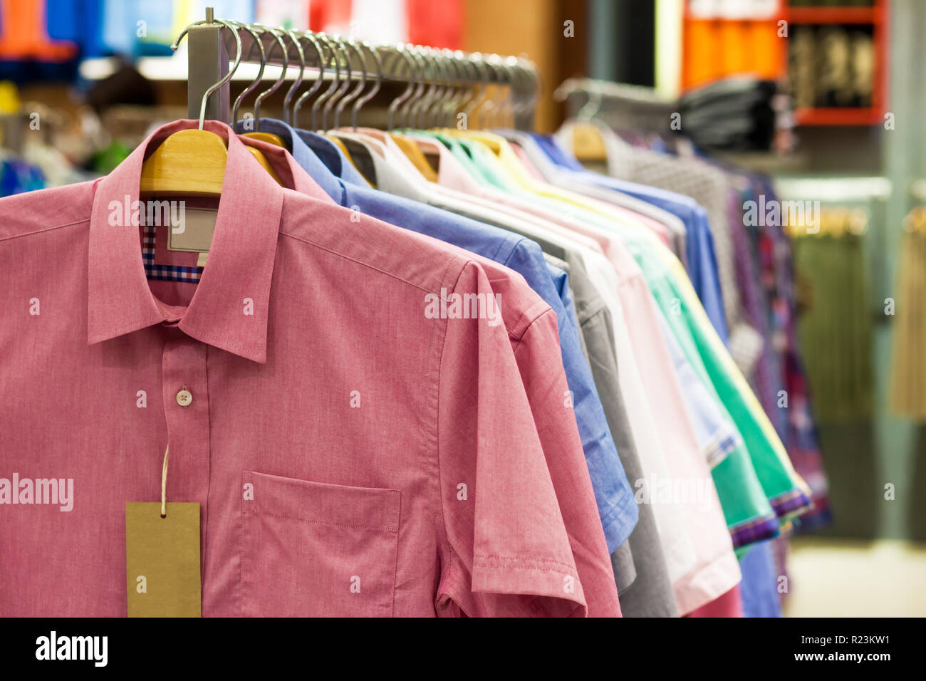 https://c8.alamy.com/comp/R23KW1/colored-shirts-on-hangers-in-a-shop-R23KW1.jpg