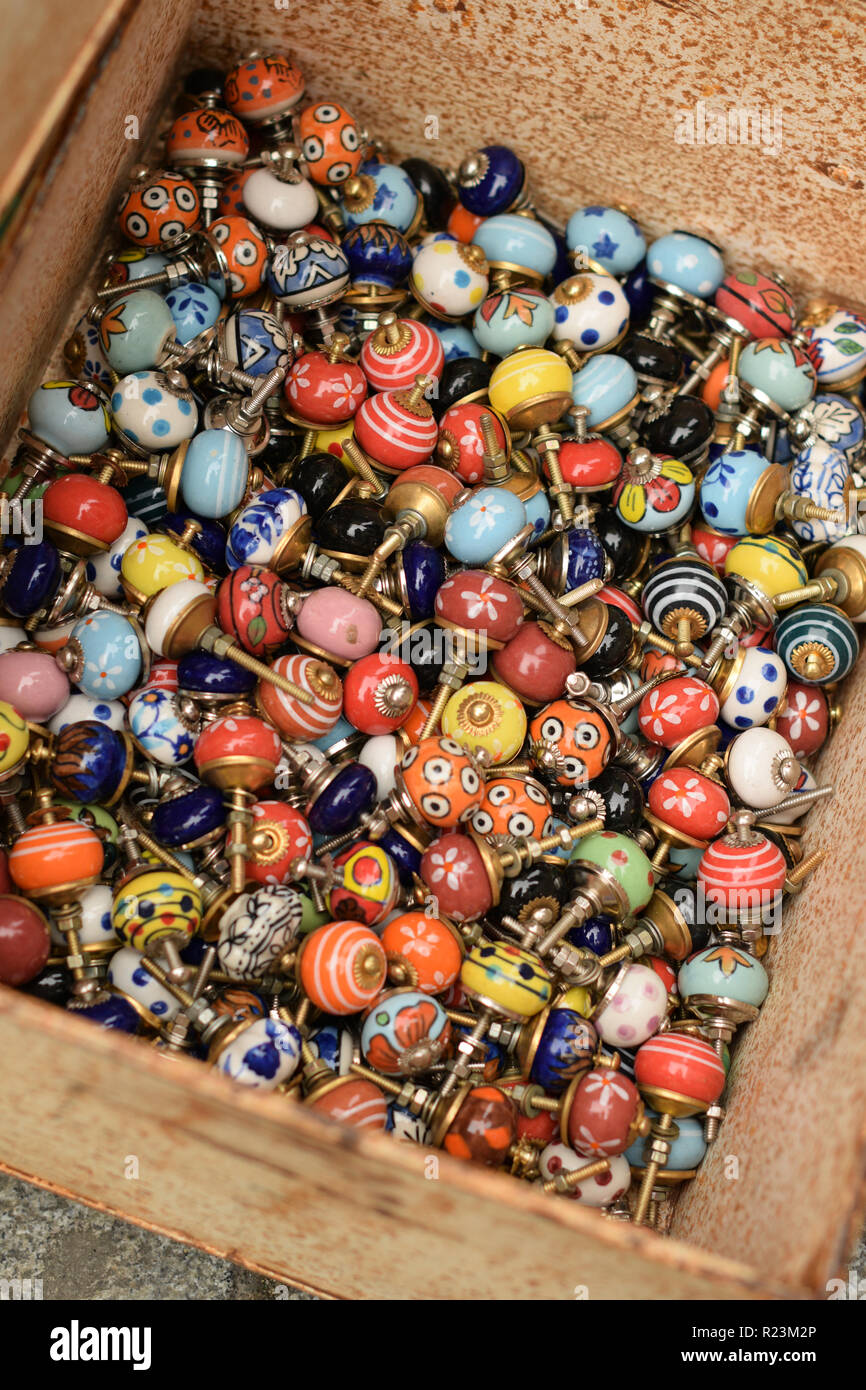 Box of colourful vintage door knobs for sale at a market Stock Photo