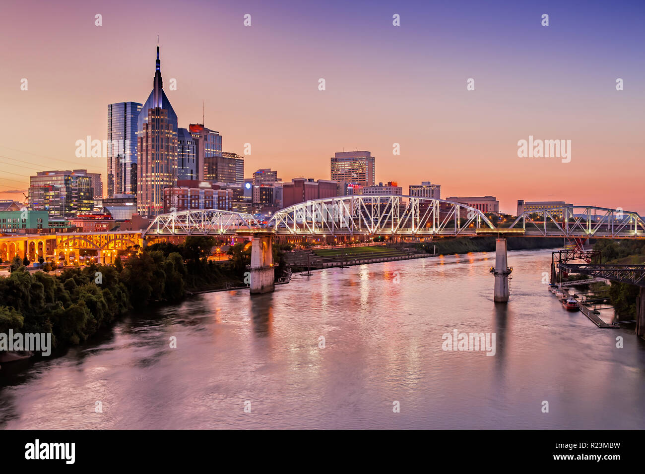 Nashville Skyline and John Seigenthaler Pedestrian Bridge at Dusk Stock Photo