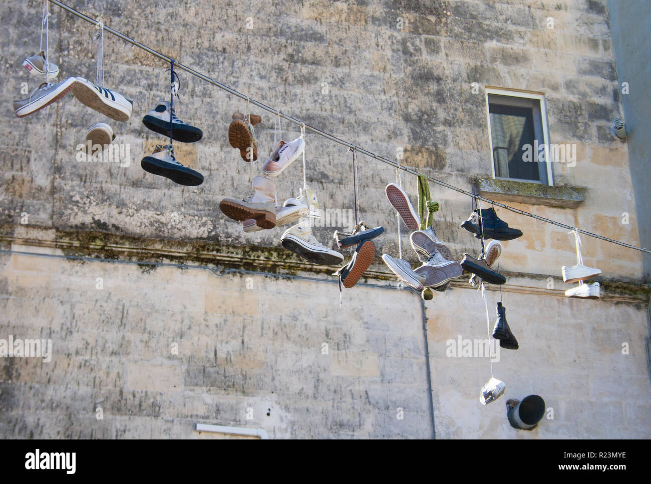 Shoes hanging. Sassi or stones of Matera European capital of culture 2019, Basilicata, Italy Stock Photo
