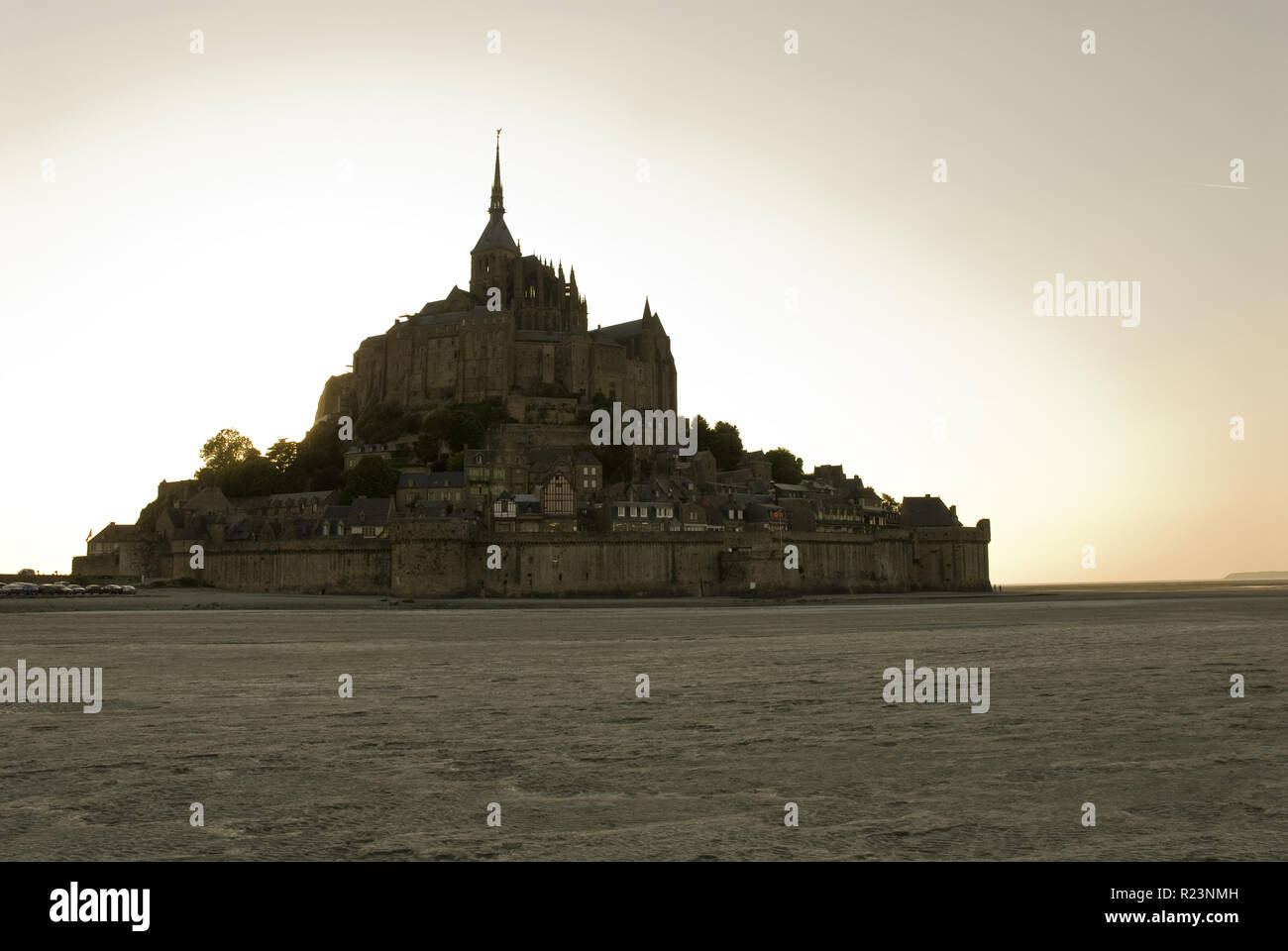 Sand flats are exposed during low tide at Mont-Saint-Michel (Le Mont-Saint-Michel), an island in Normandy, France known for its monastery. Stock Photo