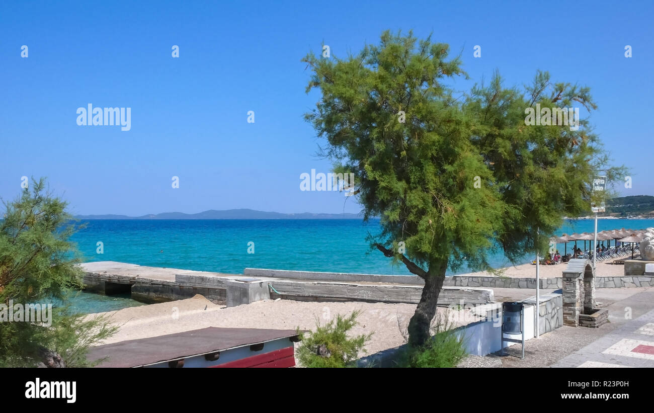 IERISSOS, GREECE - JULY 23, 2012: Beach and costal street at town of Ierissos, Athos, Chalkidiki, Central Macedonia, Greece Stock Photo