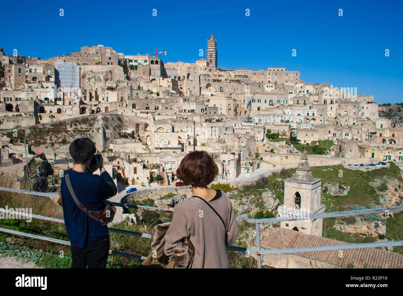 Tourists looking at the panoramic beautiful view of Sassi or stones of Matera, European capital of culture 2019, Basilicata, Italy Stock Photo