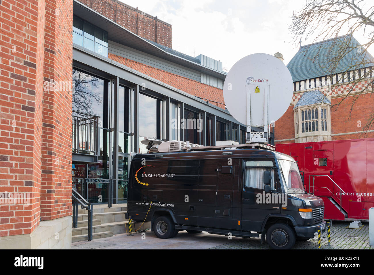 Outside broadcast van with large satellite dish outside the Royal Shakespeare Theatre in Stratford-upon-Avon, Warwickshire Stock Photo