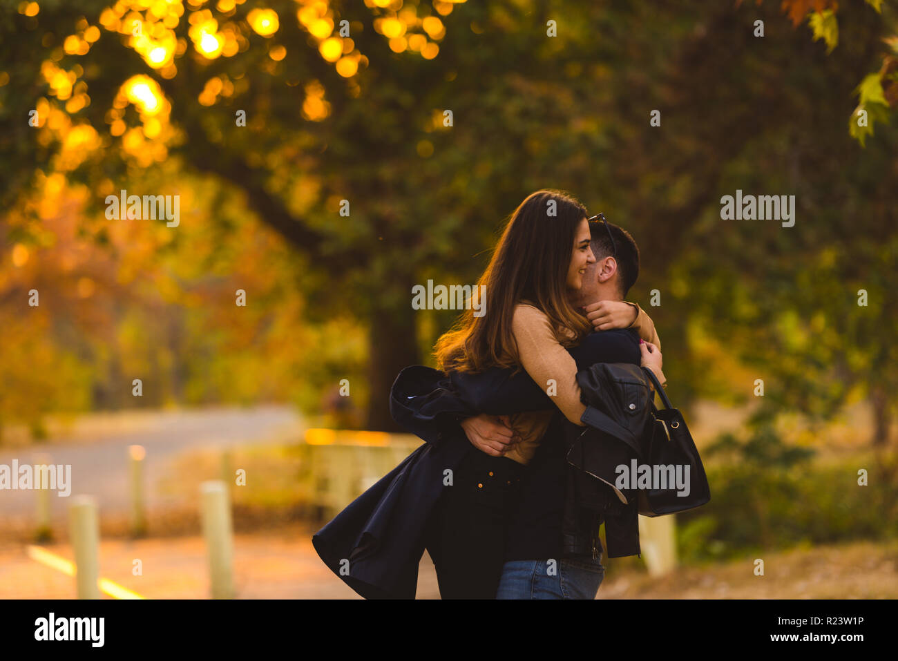 Young couple hugging and kissing at the park Stock Photo - Alamy