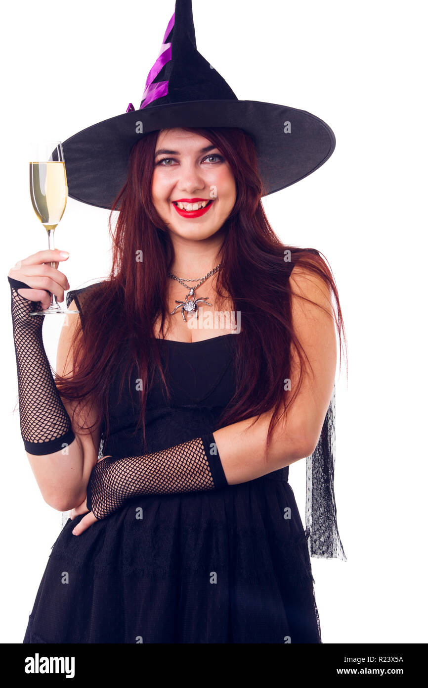 Picture of happy witch with wine glass with wine in black dress and hat Stock Photo