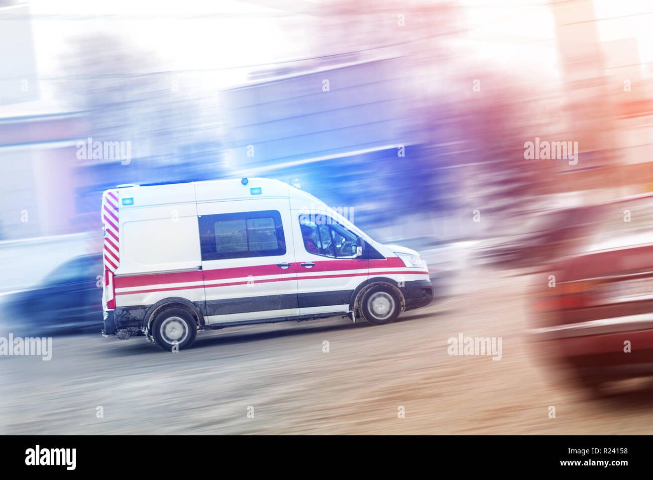 Ambulance racing through city traffic jam on slippery road with slush snow.  Car accident on highway Stock Photo - Alamy